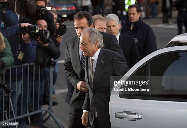 Bernard Madoff, founder of Bernard L. Madoff Investment Securities LLC, is escorted into federal court in New York, U.S., on Thursday, March 12,...