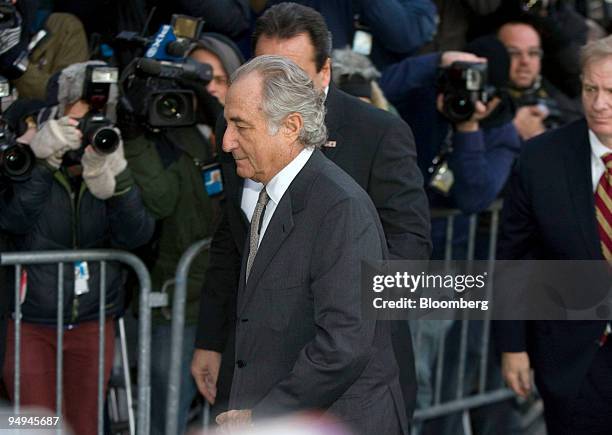 Bernard Madoff, founder of Bernard L. Madoff Investment Securities LLC, is escorted into federal court in New York, U.S., on Thursday, March 12,...