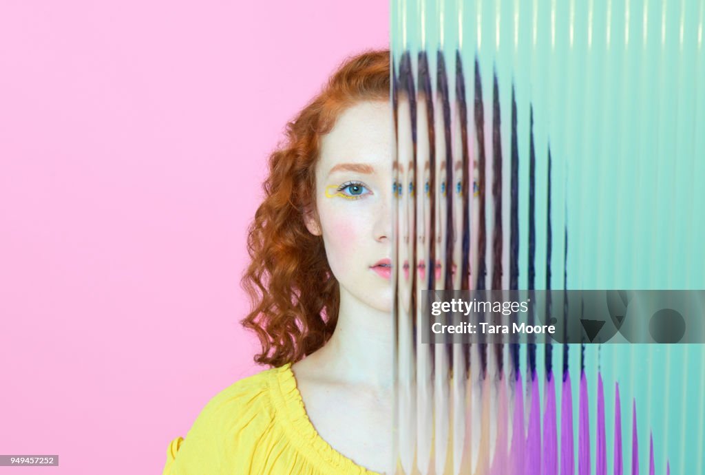 Half of woman's face obscured by glass