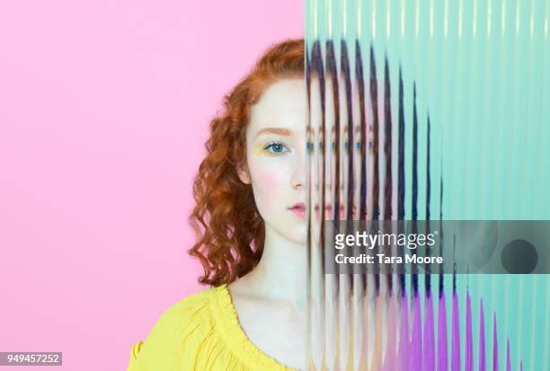 half of woman's face obscured by glass - separation foto e immagini stock