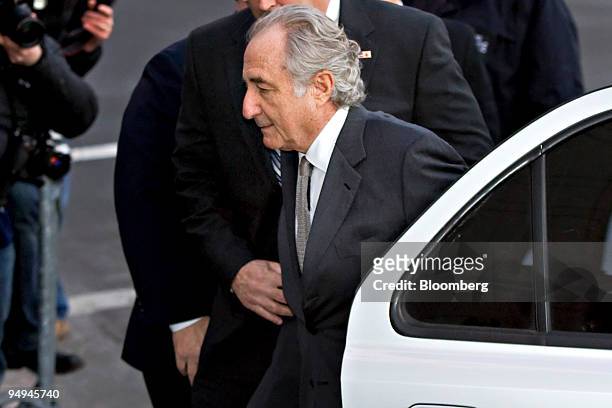 Bernard Madoff, founder of Bernard L. Madoff Investment Securities LLC, is escorted into federal court in New York, U.S., on Thursday, March 12,...