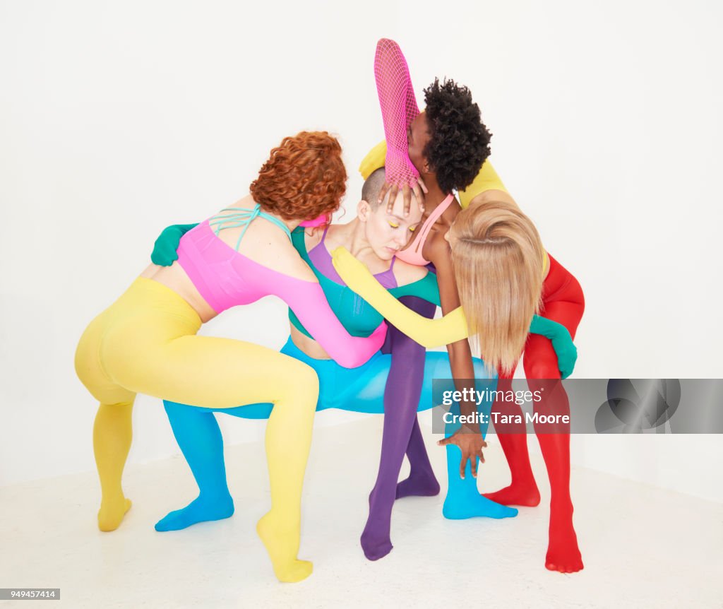 People entwined in colourful clothing