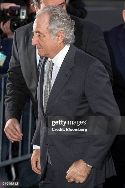 Bernard Madoff, founder of Bernard L. Madoff Investment Securities LLC, is escorted into federal court in New York, U.S., on Thursday, March 12,...