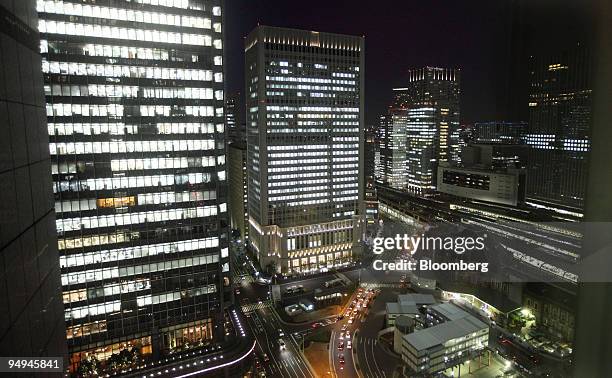 Office buildings including one which houses the Hitachi Ltd. Headquarters, center, stand at night in Tokyo, Japan, on Friday, Feb. 6, 2009. Japan's...