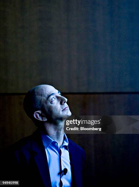 Jeff Bezos, chairman, president and chief executive officer of Amazon.com Inc., watches a video presentation during a news conference in New York,...