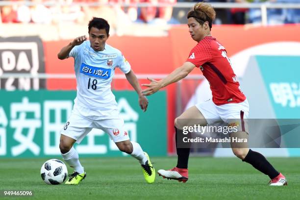 Chanathip of Consadole Sapporo and Kazuki Nagasawa of Urawa Red Diamonds compete for the ball during the J.League J1 match between Urawa Red Diamonds...