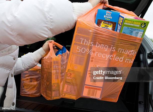 Customer places carrier bags into the back of her car at a Sainsbury's supermarket in Newbury Park, Essex, U.K., on Wednesday, May 13, 2009. J...