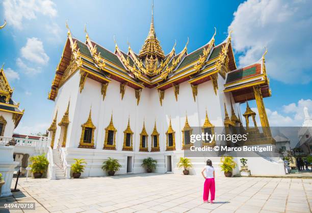 Tourist woman admiring the architecture at Royal Palace, Bangkok, Thailand