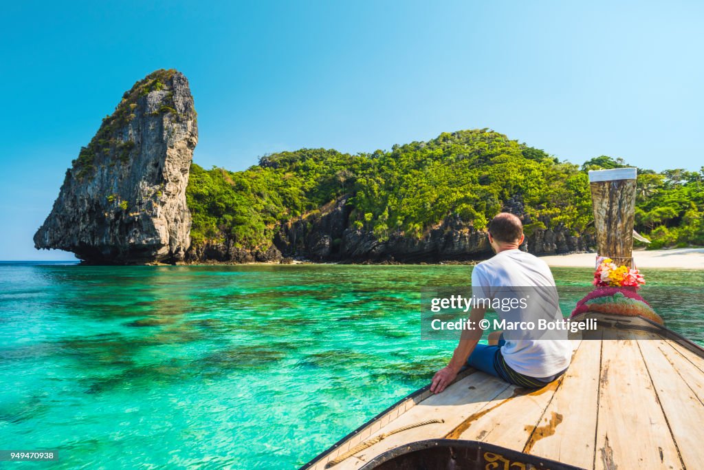 Tourist sitting on a longtail boat in Phi Phi Island, Thailand
