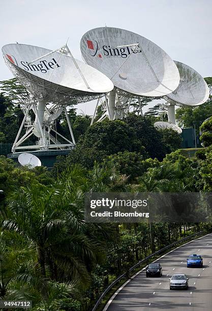 Cars travel past the Singapore Telecommunications Ltd. Satellite up-link station, in Singapore, on Thursday, May 14, 2009. Singapore...