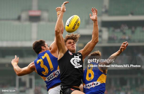 Tom Barrass of the Eagles, Charlie Curnow of the Blues and Jack Redden of the Eagles compete for the ball during the 2018 AFL round five match...