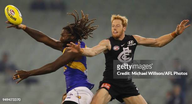 Nic Naitanui of the Eagles and Andrew Phillips of the Blues compete for the ball during the 2018 AFL round five match between the Carlton Blues and...