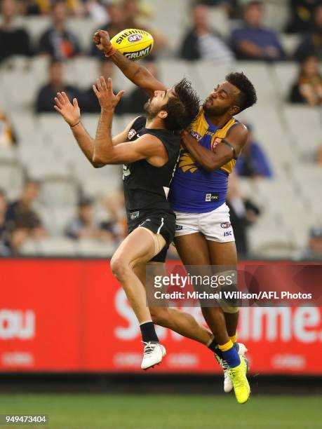 Kade Simpson of the Blues and Willie Rioli of the Eagles compete for the ball during the 2018 AFL round five match between the Carlton Blues and the...
