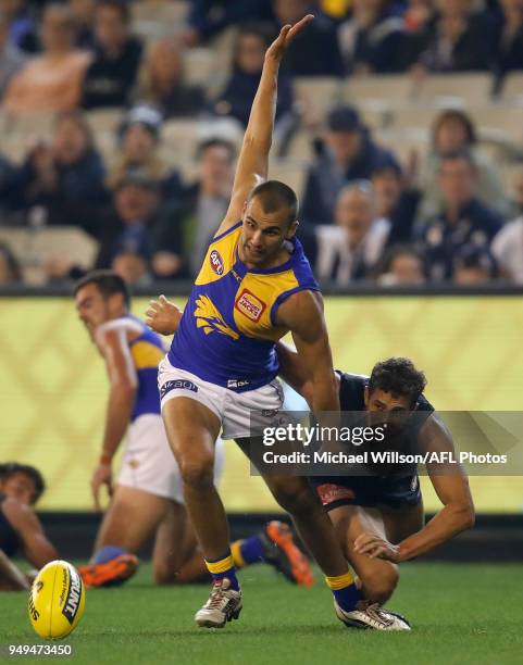 Dom Sheed of the Eagles is tackled by Ed Curnow of the Blues during the 2018 AFL round five match between the Carlton Blues and the West Coast Eagles...