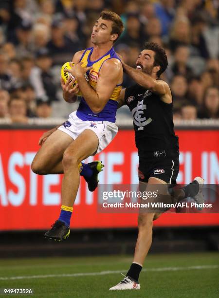 Jamie Cripps of the Eagles and Kade Simpson of the Blues compete for the ball during the 2018 AFL round five match between the Carlton Blues and the...