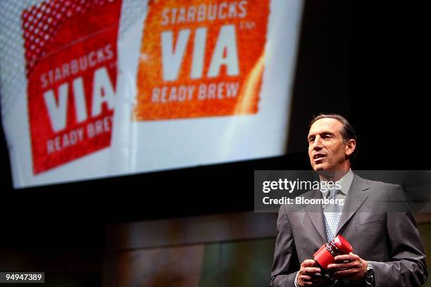Howard Schultz, chairman and chief executive officer of Starbucks Corp., holds a jar of non-Starbucks instant coffee while promoting the brand's new...