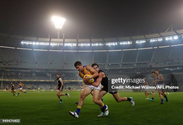 Liam Duggan of the Eagles is tackled by Jed Lamb of the Blues during the 2018 AFL round five match between the Carlton Blues and the West Coast...