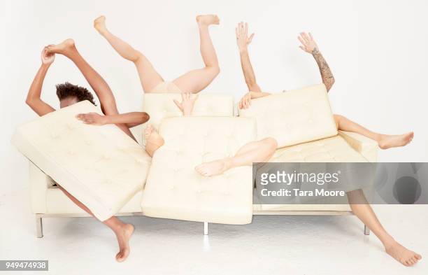legs sticking out of sofa - limb body part stock pictures, royalty-free photos & images