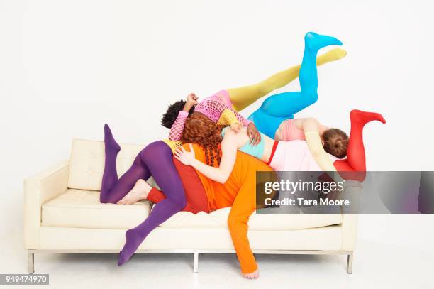 group of people piled onto sofa - women wearing thigh high stockings stock pictures, royalty-free photos & images