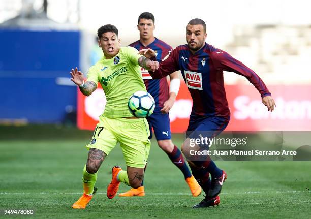 Mathias Olivera of Getafe CF duels for the ball with Pedro Leon of SD Eibar during the La Liga match between SD Eibar and Getafe CF at Ipurua...