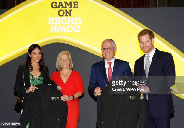 Prince Harry and Meghan Markle receive Invictus Games jackets from Malcolm Turnbull, Prime Minister of Australia and his wife Lucy Turnbull during...