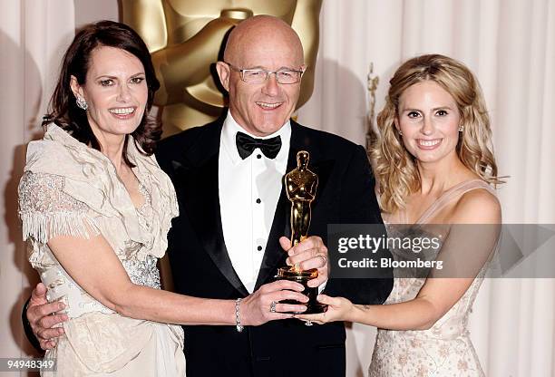 Actor Heath Ledger's mother Sally Bell, left, father Kim Ledger, and sister Kate Ledger hold his Oscar for best supporting-actor in the film "The...