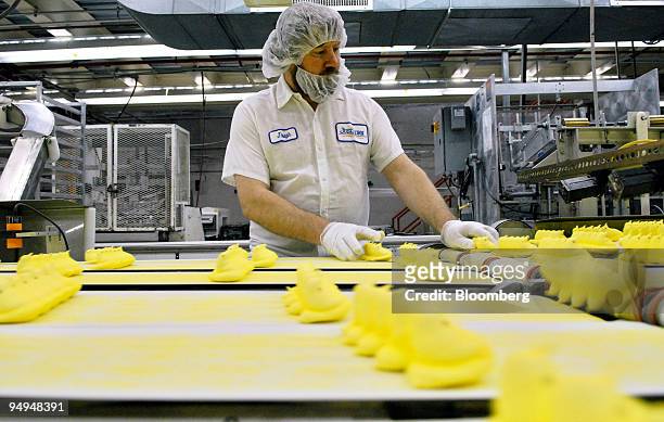 Joseph Kovacevic performs quality control as Marshmallow candy Peeps chicks move down a conveyor belt inside the Just Born Inc. Manufacturing...