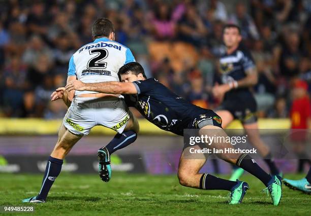 Anthony Don of the Titans is tackled by Lachlan Coote of the Cowboys during the round seven NRL match between the North Queensland Cowboys and the...