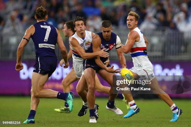 Stephen Hill of the Dockers gets tackled by Patrick Lipinski of the Bulldogs during the round five AFL match between the Fremantle Dockers and the...