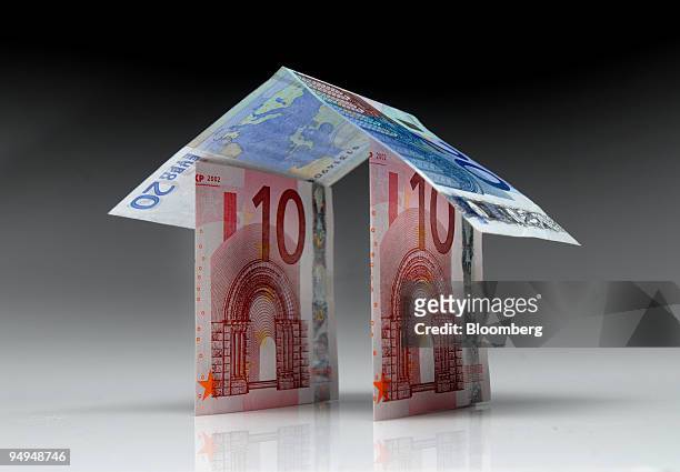 Euro notes form the shape of a house in Paris, France, on Monday, April 27, 2009. German Finance Minister Peer Steinbrueck said that the euro region...