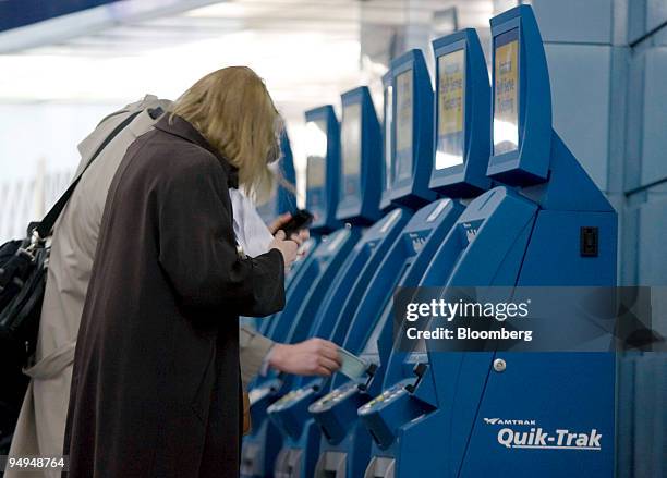 Customers purchase Amtrak tickets at an automated ticketing booth at Pennsylvania Station in New York, U.S. On Wednesday, March 25, 2009....