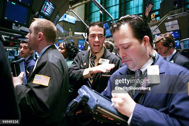 Trader Gregory Rowe, center, works on the floor of the New York Stock Exchange in New York, U.S., on Friday, Feb. 27, 2009. U.S. And European stocks...