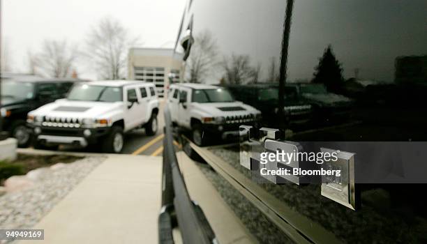 Hummer H3 is reflected in the door of an H2 at the Detroit Hummer dealership in Southfield, Michigan, U.S., on Thursday, March 26, 2009. General...