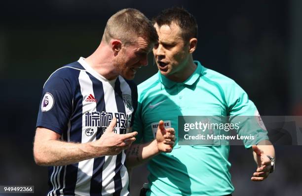 Referee Stuart Attwell speaks to Chris Brunt of West Bromwich Albion during the Premier League match between West Bromwich Albion and Liverpool at...