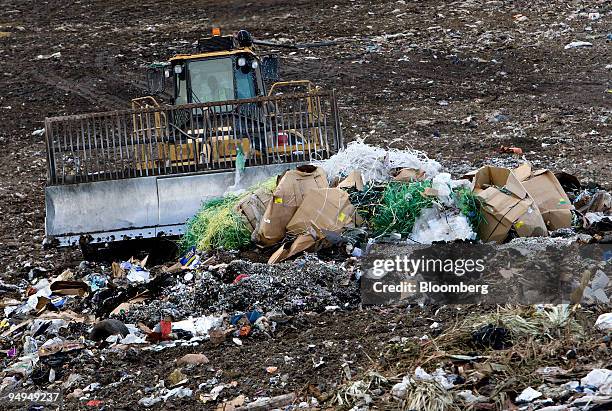 Caterpillar 836H landfill compactor drives over the active face of the Waste Management Central Landfill in Pompano Beach, Florida, U.S., on Friday,...