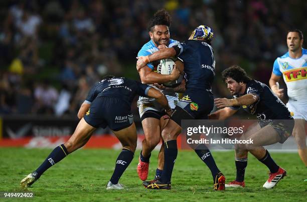 Konrad Hurrell of the Titans is tackled by Johnathan Thurston and Justin O'Neil of the Cowboys during the round seven NRL match between the North...