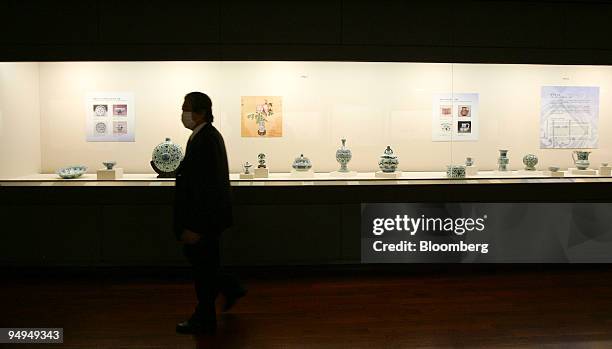 Visitor passes Ming Dynasty antique pottery pieces with light bluish-green glaze at the Taiwan National Palace Museum in Taipei, Taiwan, on...