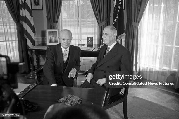 President Dwight D Eisenhower talks with French President Charles de Gaulle in the White House's Oval Office, Washington DC, April 25, 1960.