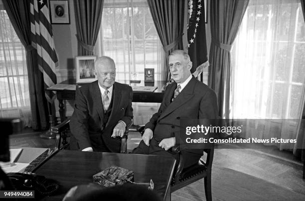 President Dwight D Eisenhower talks with French President Charles de Gaulle in the White House's Oval Office, Washington DC, April 25, 1960.