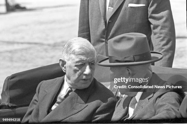 French President Charles de Gaulle and US President Dwight D Eisenhower talk together as they ride in a limousine as they leave Washington National...