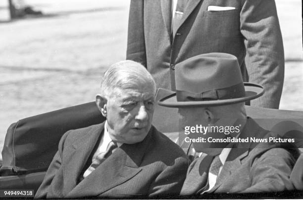 French President Charles de Gaulle and US President Dwight D Eisenhower talk together as they ride in a limousine as they leave Washington National...