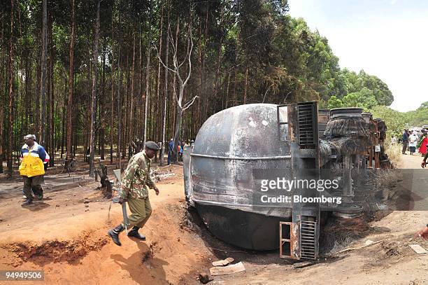 Police officer and pedestrians inspect the burnt out shell of the petrol tanker in Molo, Kenya, on Sunday, Feb. 1, 2009. Kenya?s Prime Minister Raila...