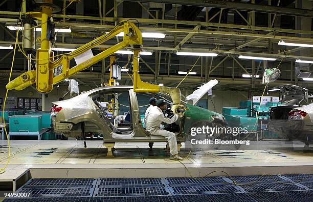Honda Siel Cars India Ltd. Employees work on the assembly line at the company's production plant in Noida, India, on Thursday, March 12, 2009....