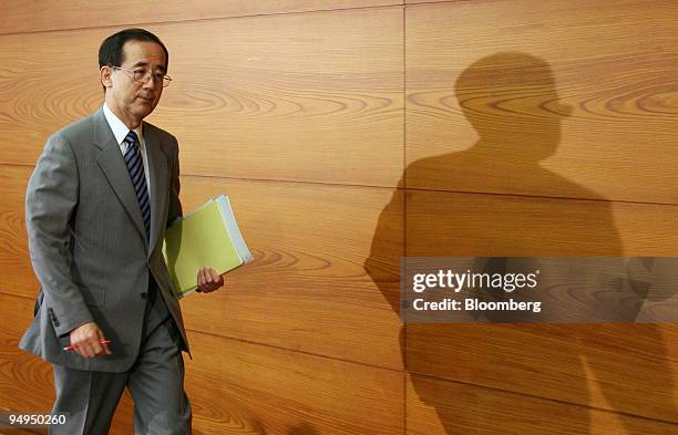 Masaaki Shirakawa, governor of the Bank of Japan, leaves a news conference at the central bank's headquarters in Tokyo, Japan, on Friday, May 22,...