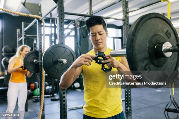 Enthusiast Preparing Some Gym Equipment For Use