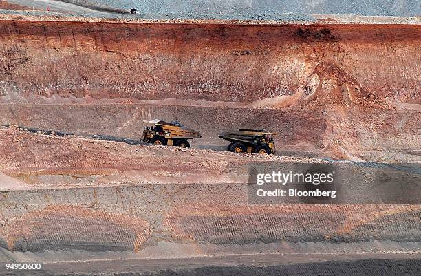 Two earth movers pass each other while retrieving copper mineral deposits from the base of an open pit mine at the OZ Minerals Ltd. Prominent Hill...