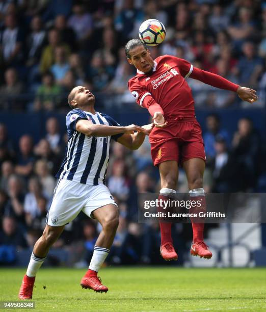 Virgil van Dijk of Liverpool wins a header under pressure from Jose Salomon Rondon of West Bromwich Albion during the Premier League match between...