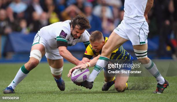 Blues fullback Gareth Anscombe contests a loose ball with Pau forward Julien Pierre as the boot of Conrad Smith waits to intervene to score their...
