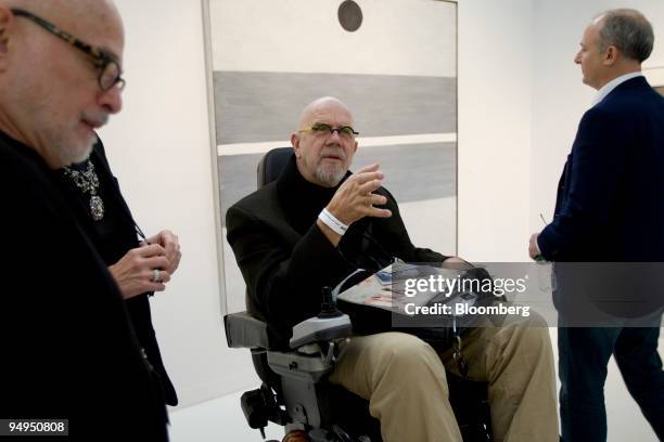 Artist Chuck Close, center, views artwork at the Pace Wildenstein booth during the Armory Show in New York, U.S., on Wednesday, March 4, 2009. The...