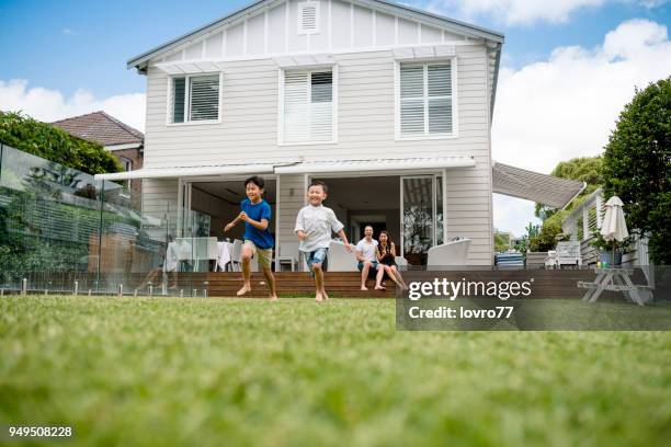 children running on backyard - summer of 77 stock pictures, royalty-free photos & images